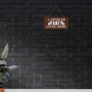 A Spoiled Cat Lives Here Wooden Wall Hanging